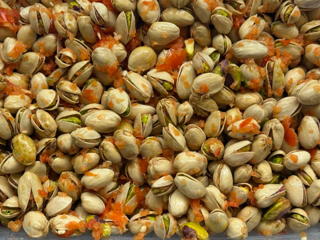 Freeze dried pistachios coated in sweet pepper puree, vibrant red-orange crunchy parrot treat handmade by Eclectus Ark