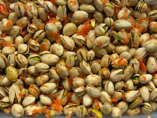 Freeze dried pistachios coated in sweet pepper puree, vibrant red-orange crunchy parrot treat handmade by Eclectus Ark